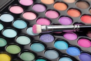 8991390-a-close-up-image-of-a-eye-shadow-set-with-a-professional-makeup-brush-with-pink-pigment-on-it