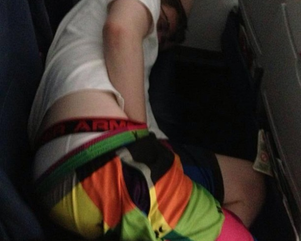 boy with underwear hanging out taking up three seats on plane