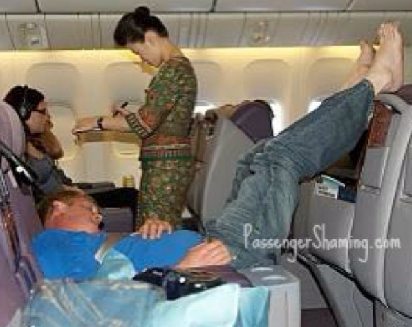 person on plane with feet in the air